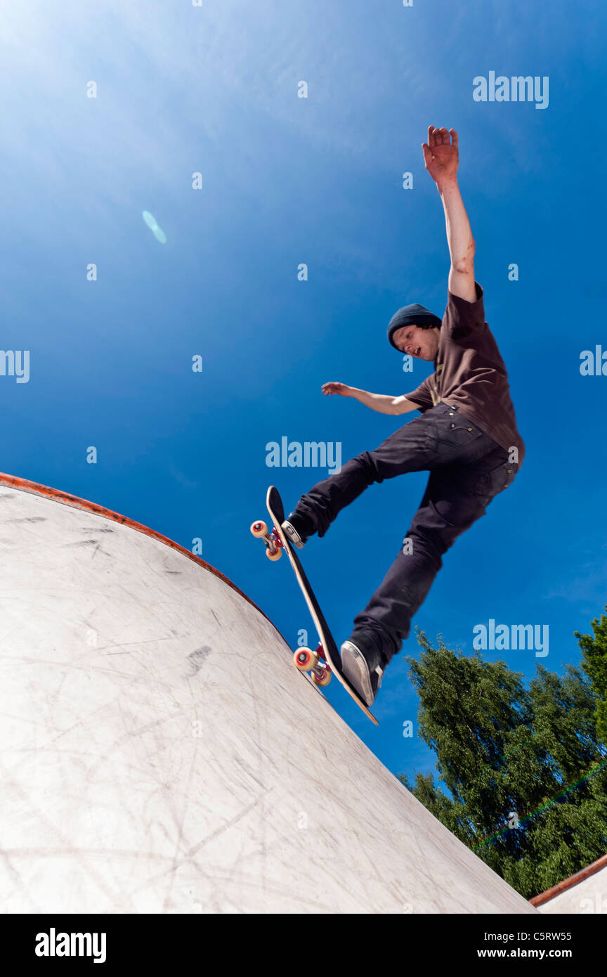 Belgium, Flemalle, Young man skate boarding in skatepark Stock Photo