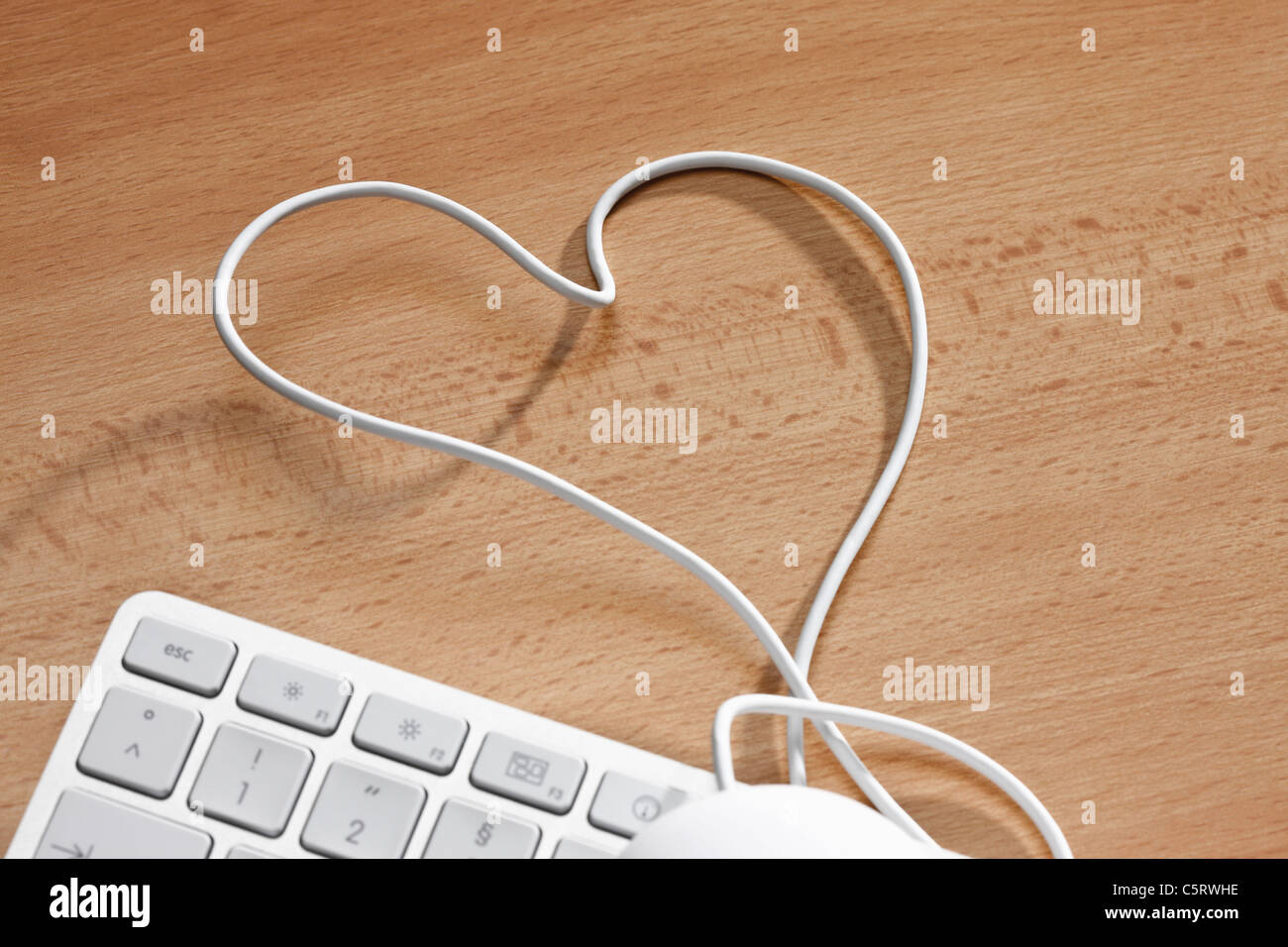 Computer keyboard with heartshape wire, elevated view Stock Photo Alamy