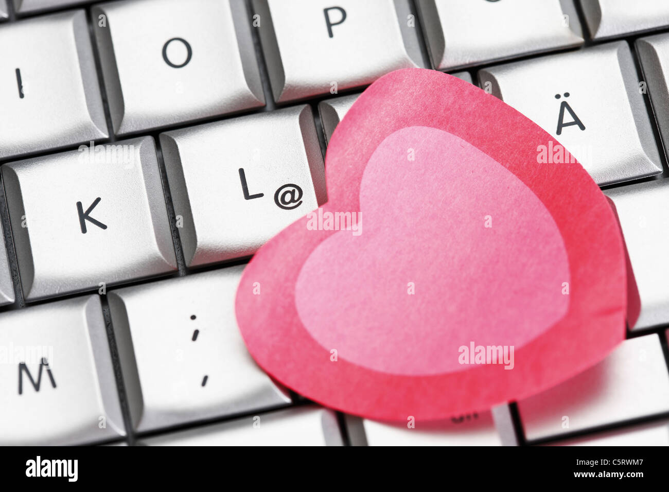 Heart-shaped notes on notebook, elevated view Stock Photo