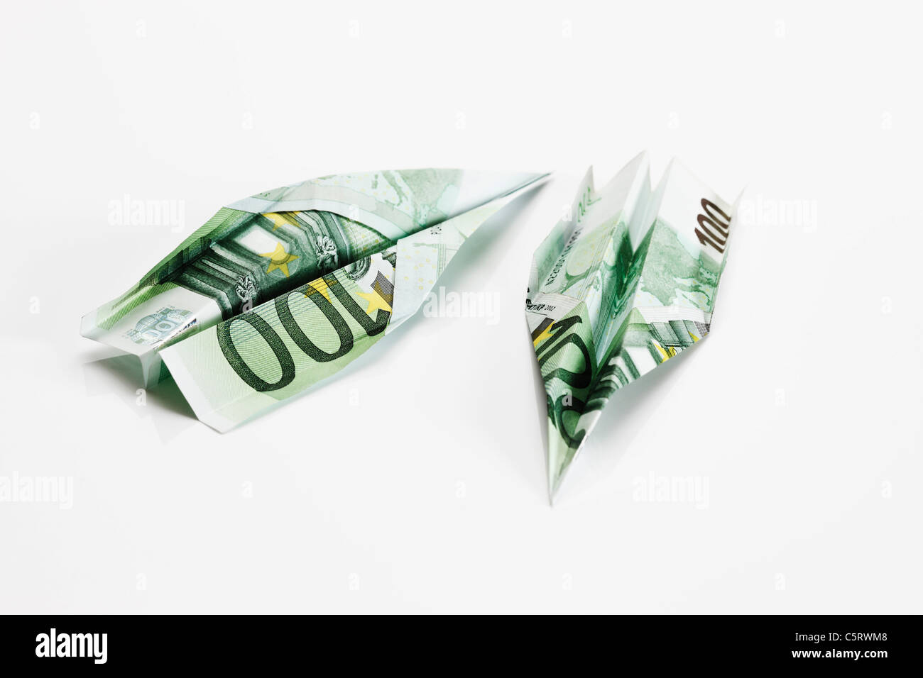 Paper aeroplanes folded from 100 Euro banknotes Stock Photo