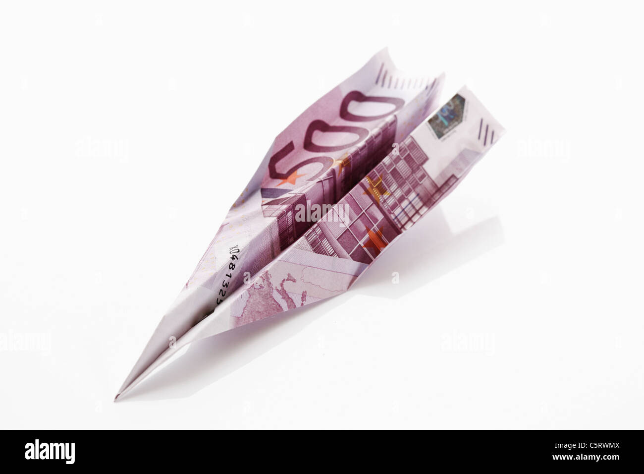 Paper aeroplane folded from 500 Euro banknote Stock Photo