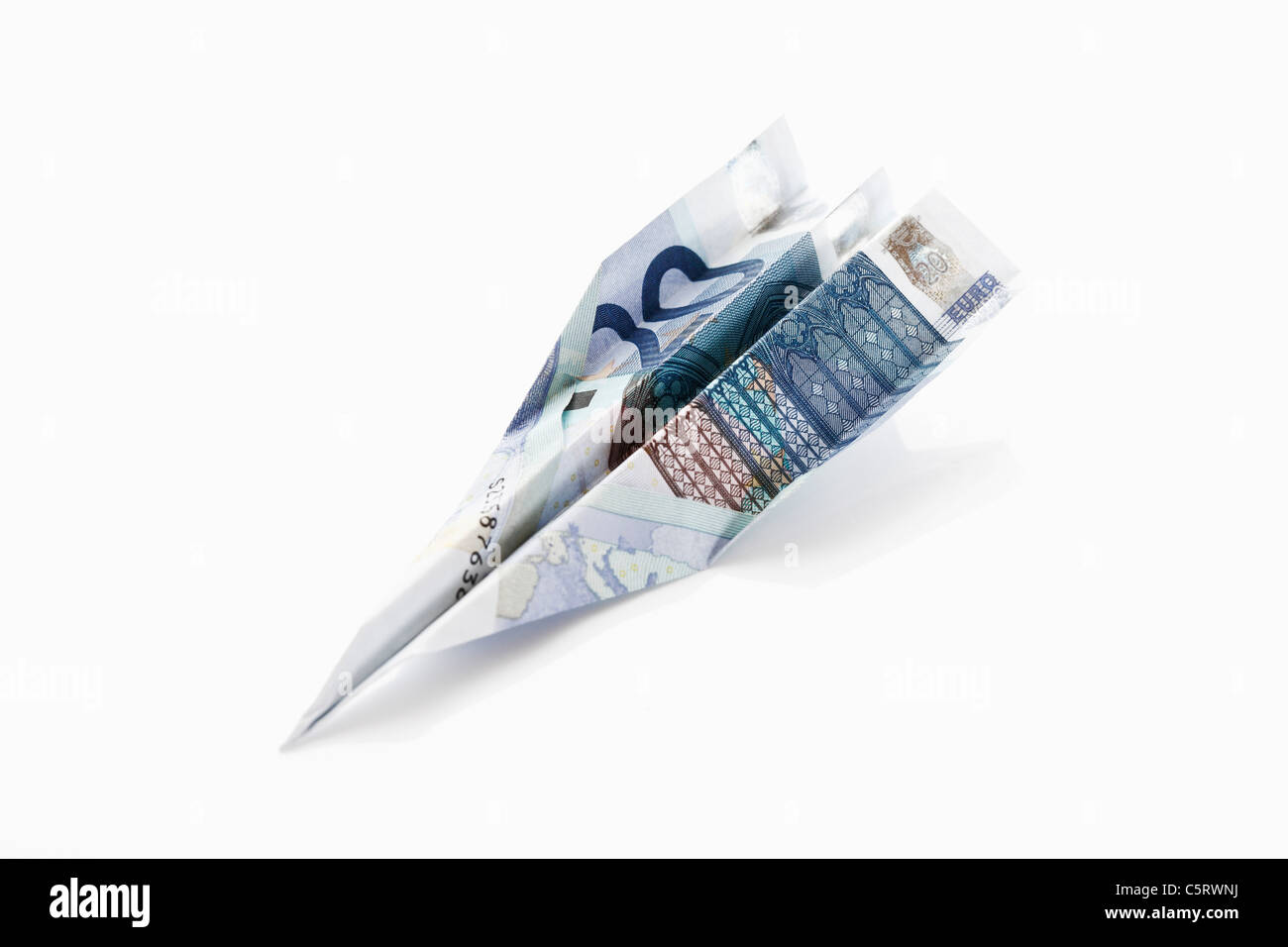 Paper aeroplane folded from 20 Euro banknote Stock Photo