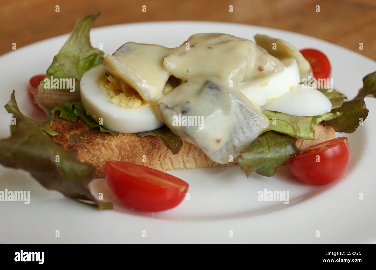 pickled herring on toast with salad Stock Photo