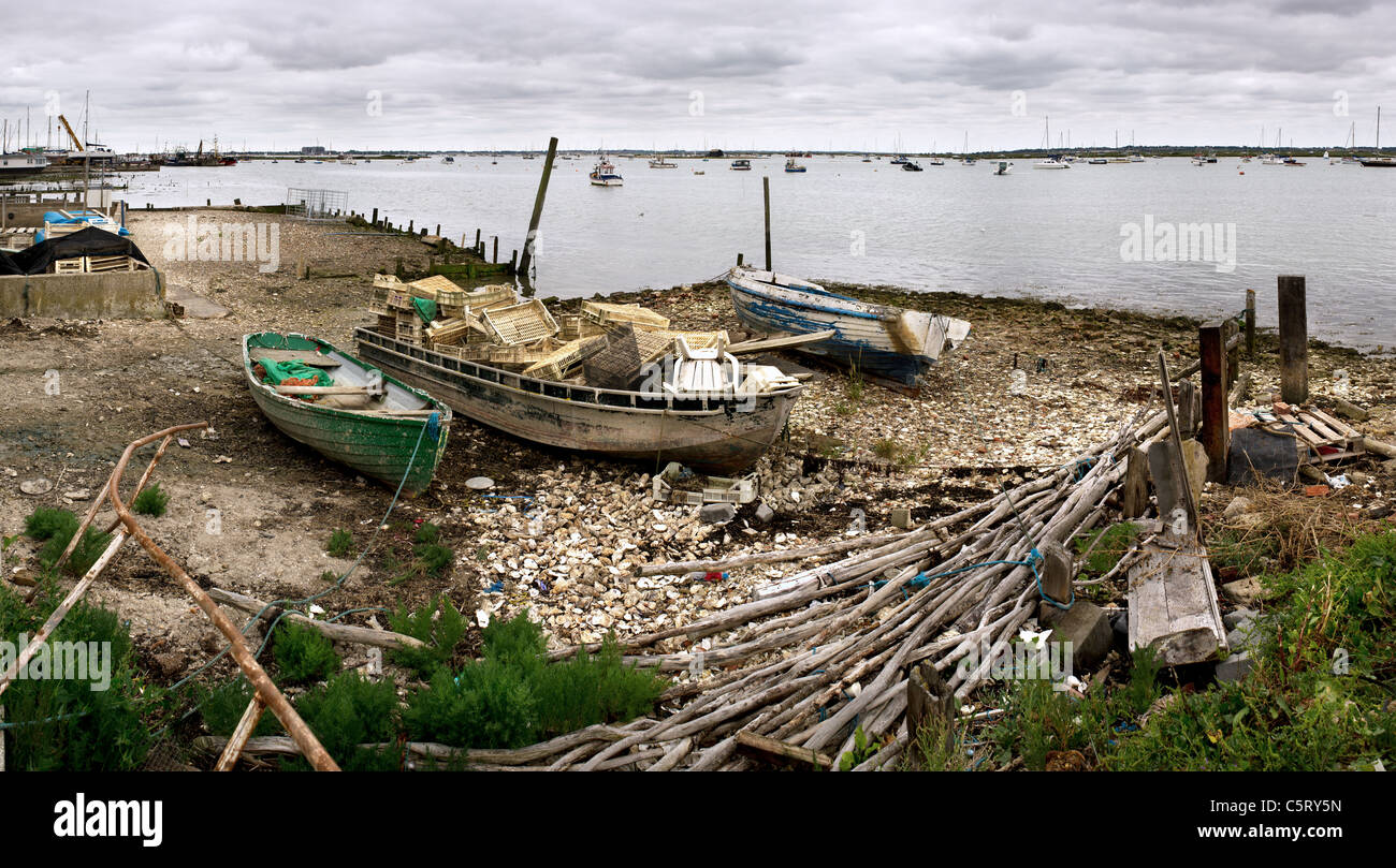 Abandoned boats on the foreshore at Mersea Island in Essex. Stock Photo