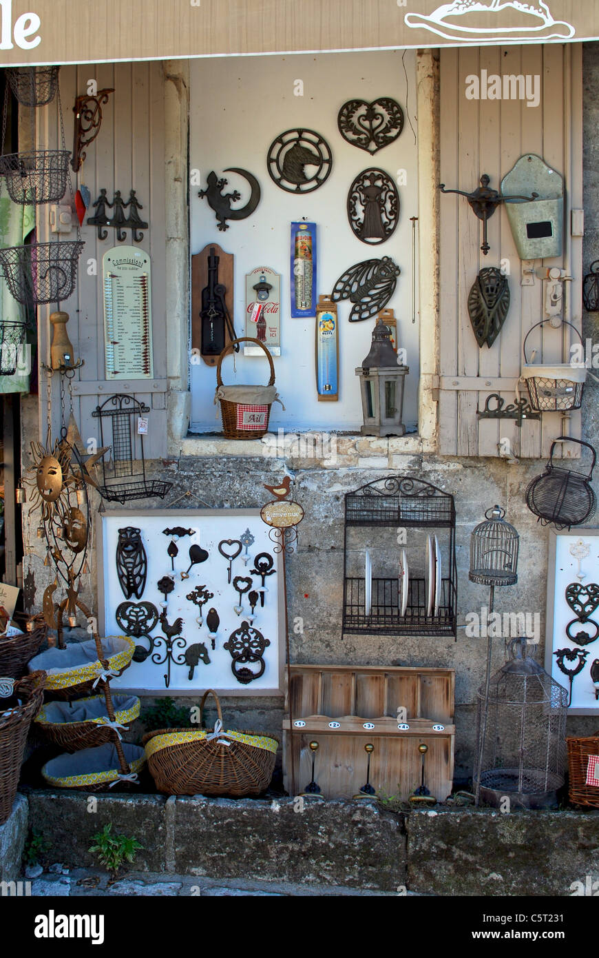 A shop selling rustic decorative objects including ironware and baskets, in Les Baux-de-Provence, France. Stock Photo