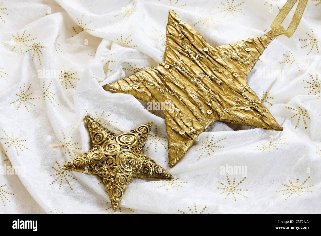 Christmas decoration, golden stars on tablecloth Stock Photo