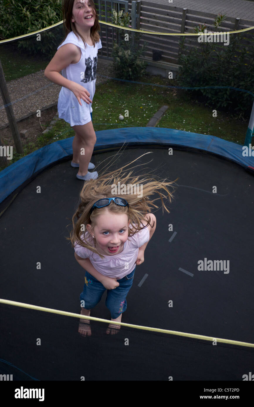 Germany, Bavaria, Two girls jumping on trampoline Stock Photo - Alamy