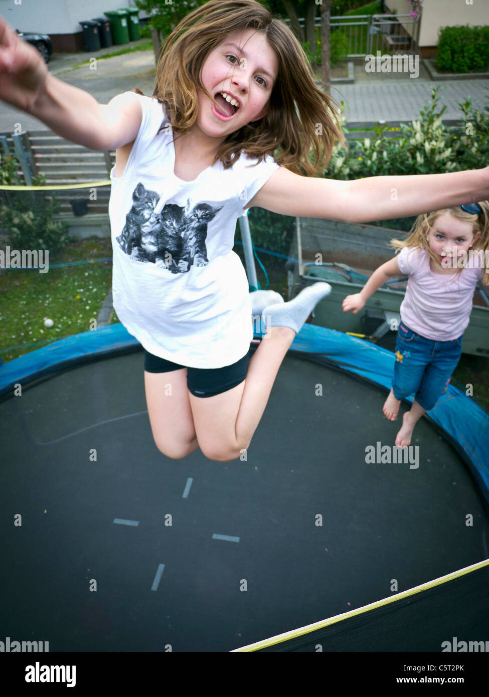 Germany, Bavaria, Two girls jumping on trampoline Stock Photo - Alamy