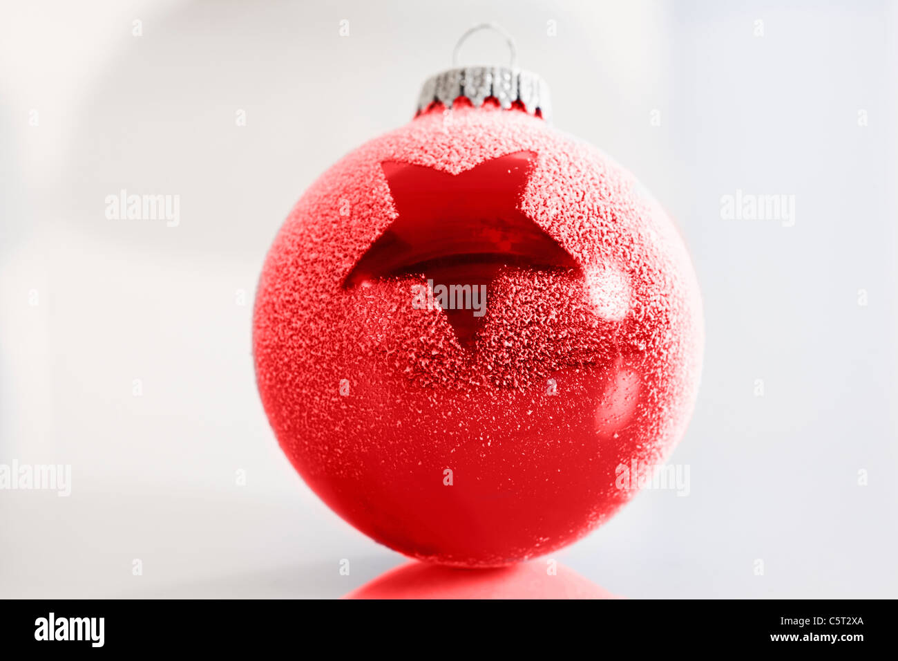 Red christmas bauble with star motive, close-up Stock Photo