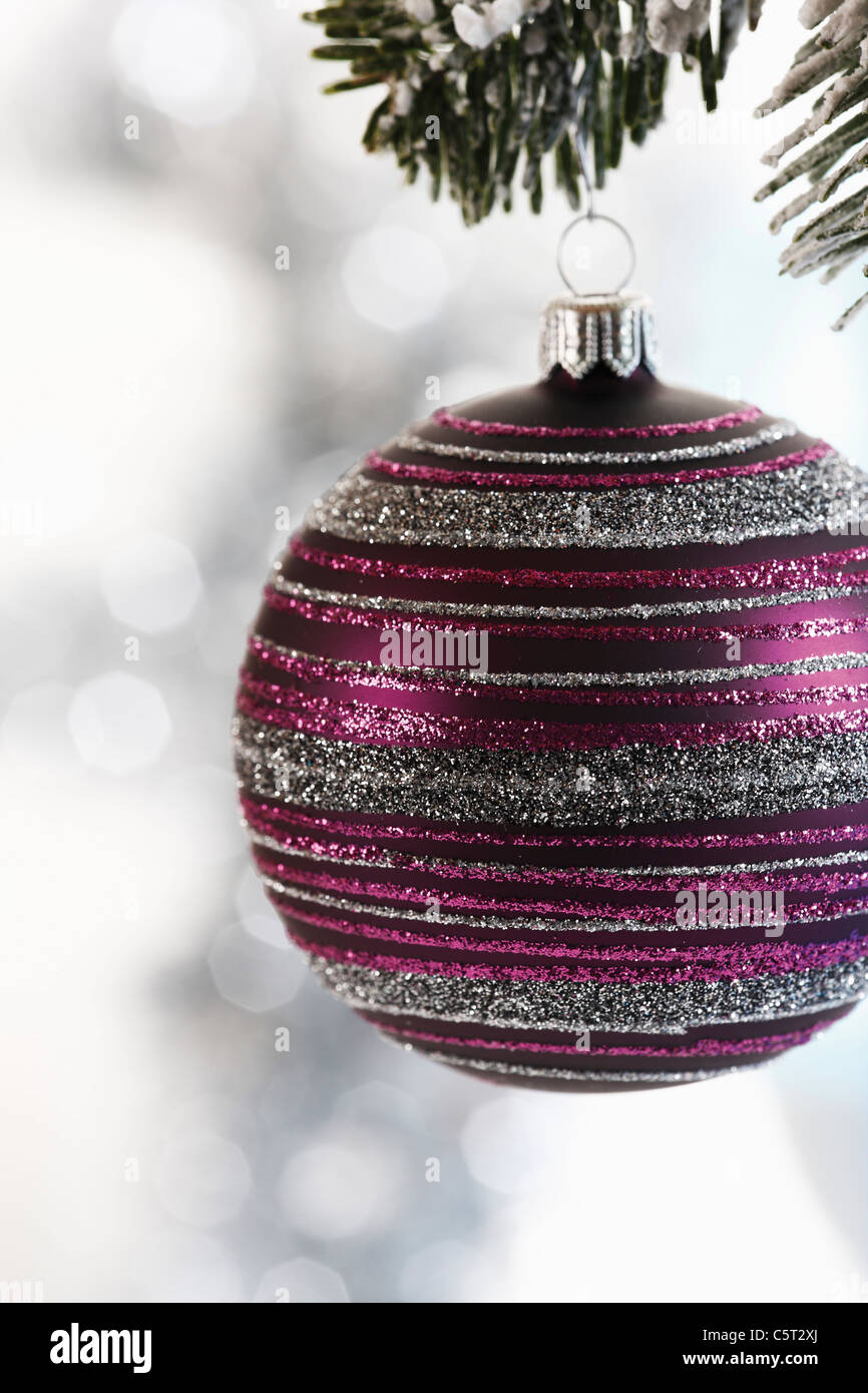 Christmas bauble hanging on fir branch, close-up Stock Photo