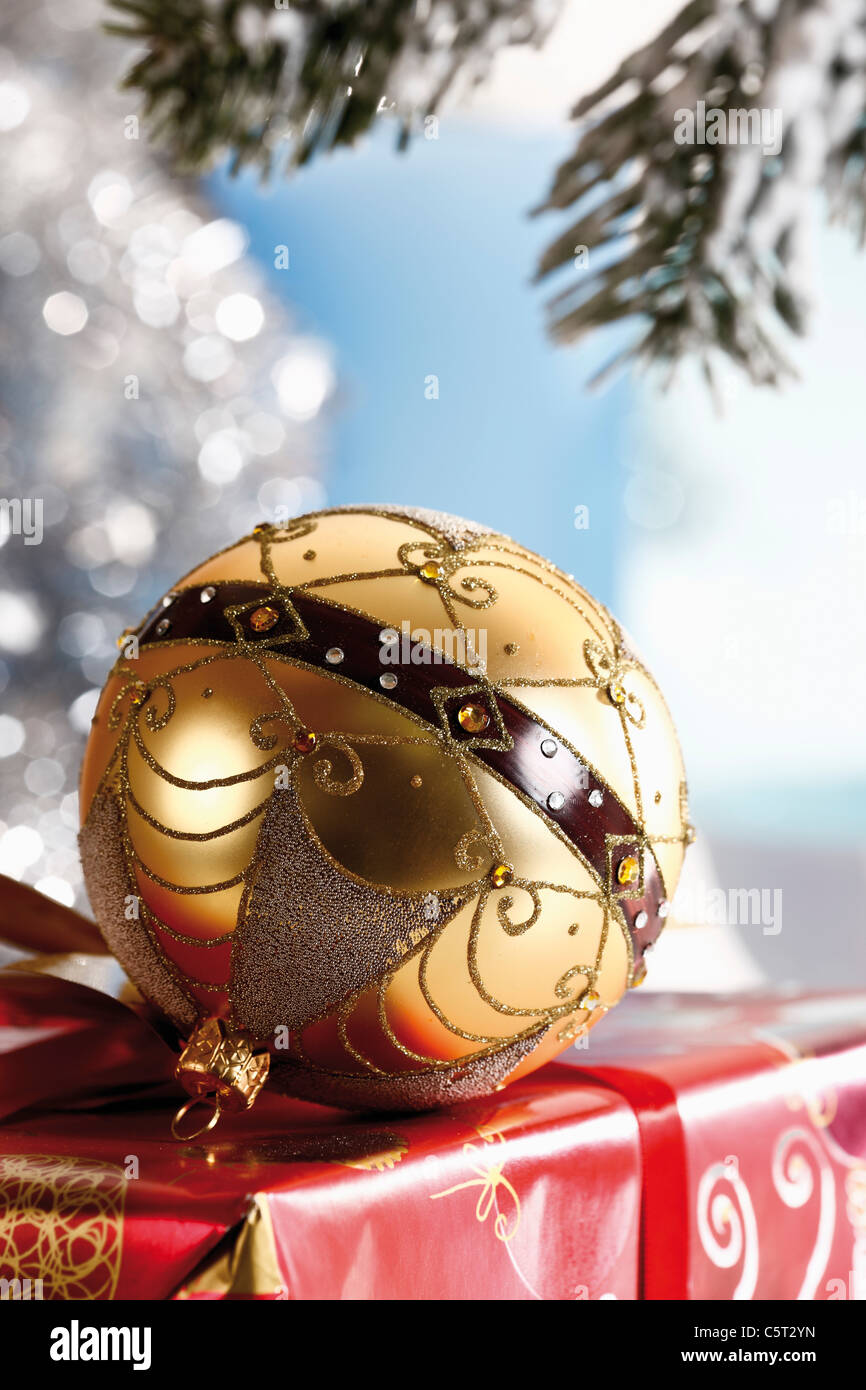 Christmas bauble on christmas parcel, close-up Stock Photo
