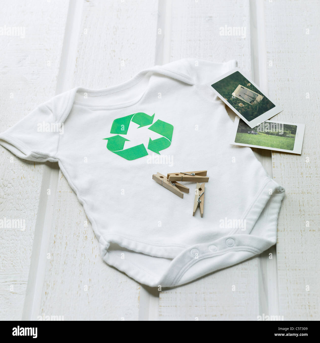 Baby's shirt, photos and clothespin Stock Photo