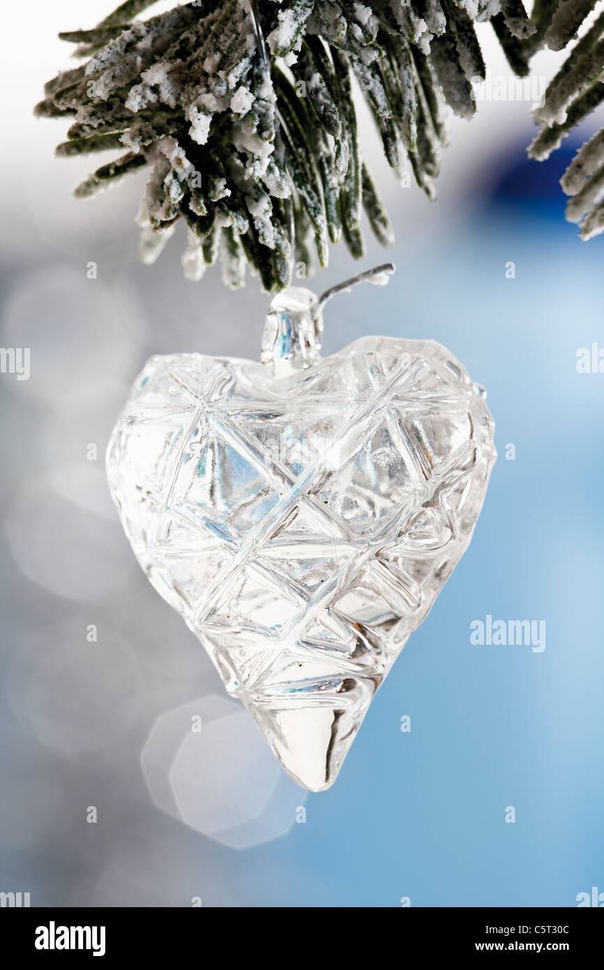 Heart-shaped Christmas tree decoration, on fir branch close-up Stock Photo