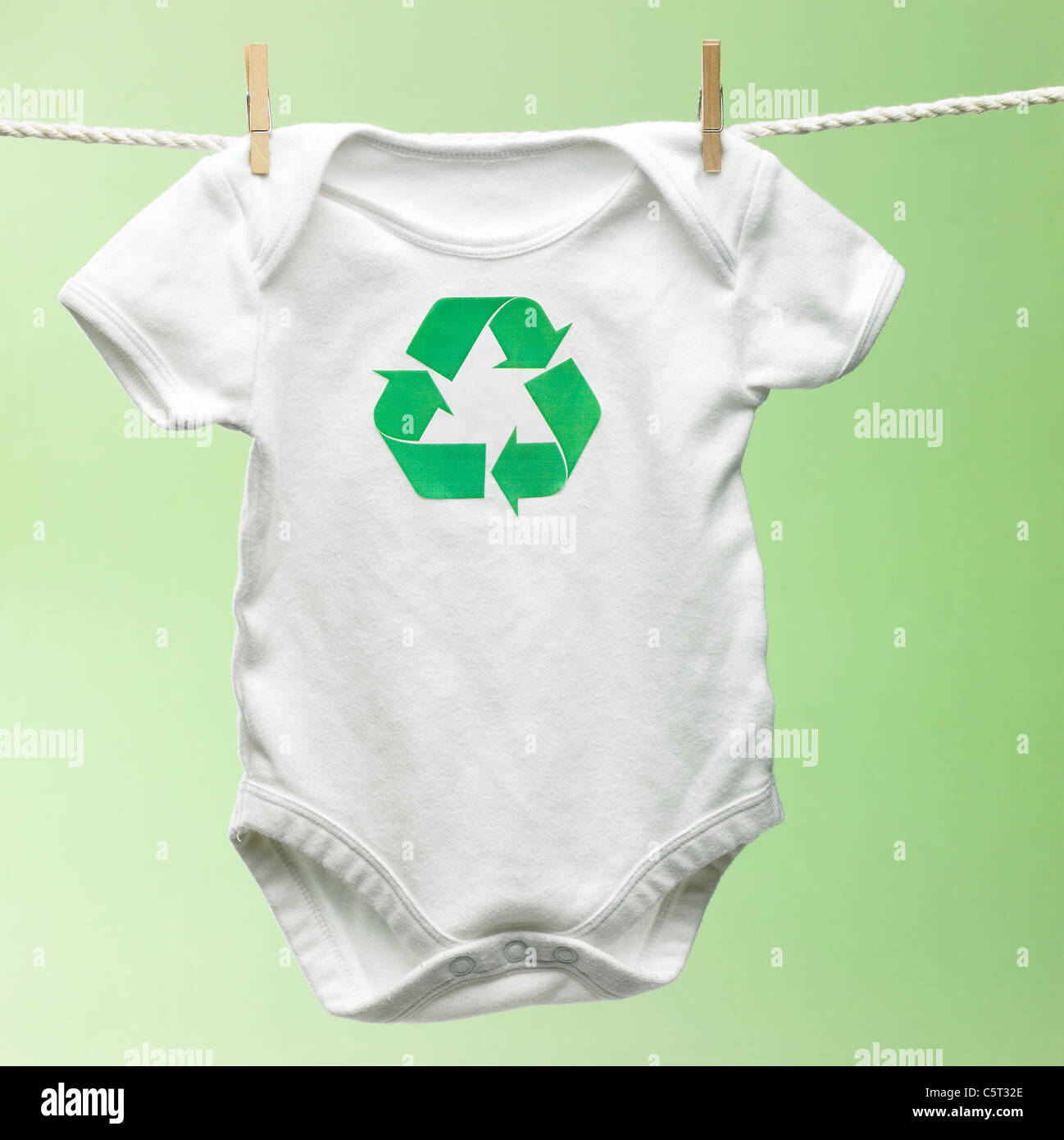 Baby's clothes with recycling mark hung on a clothesline Stock Photo Alamy