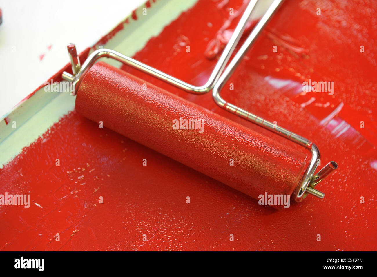 Silk screen roller in tray with red ink Stock Photo
