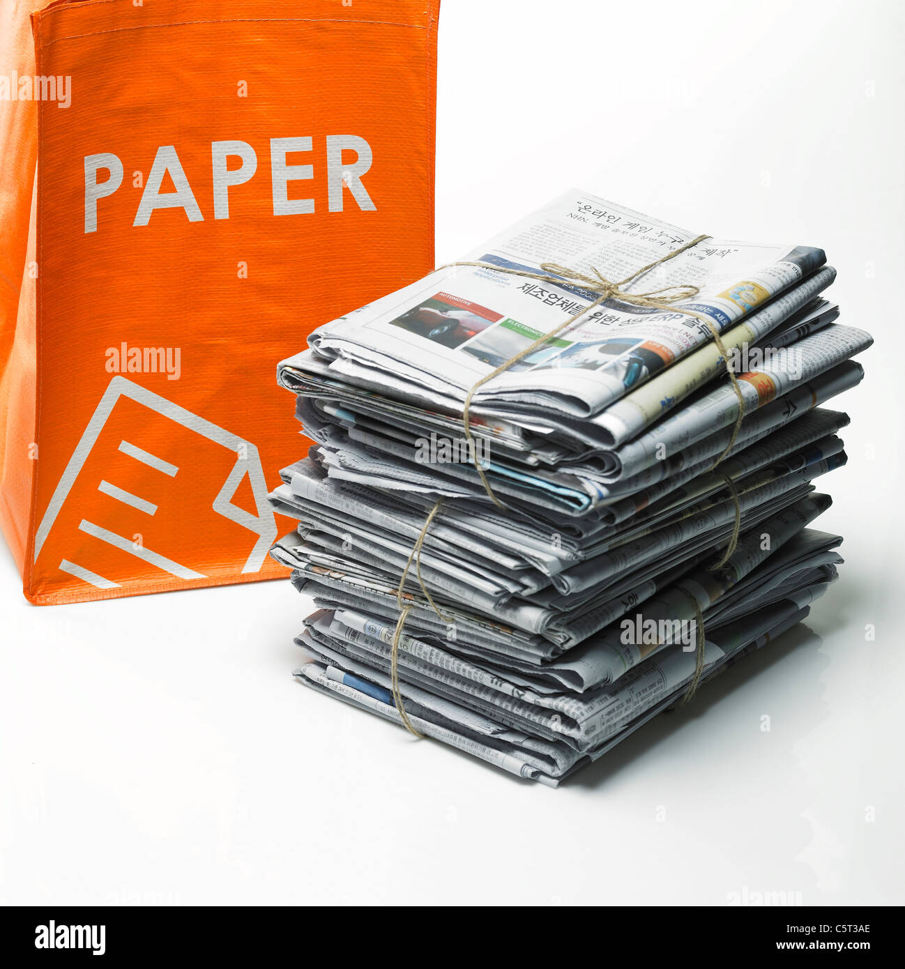 Stack of newspapers and recycling bag Stock Photo Alamy