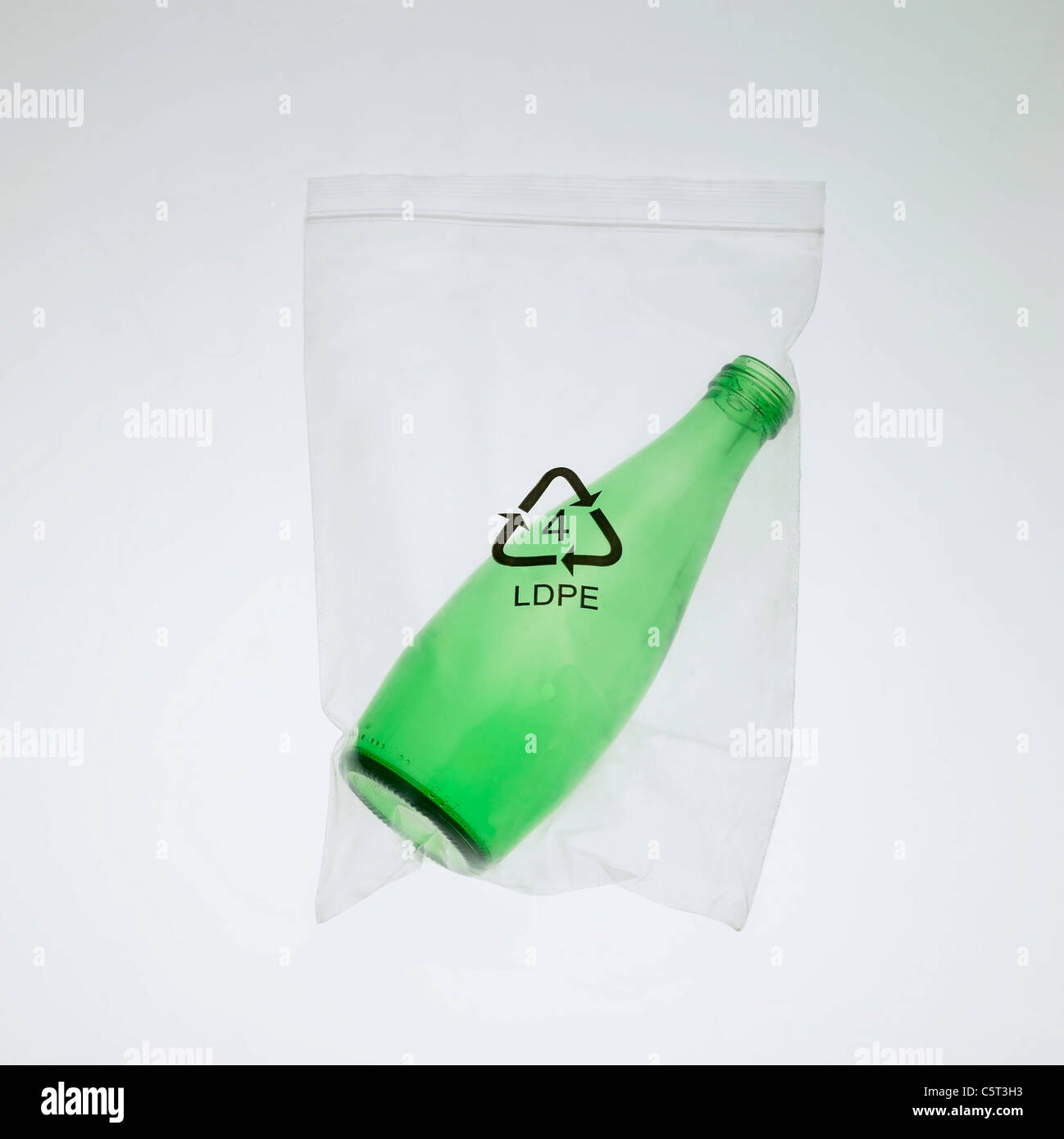 Glass bottle in a plastic bag Stock Photo