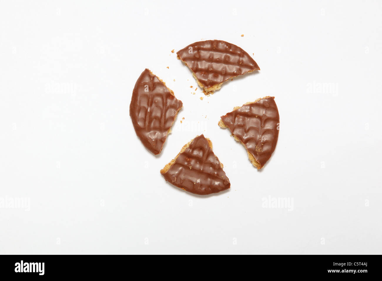 A chocolate digestive biscuit broken into quarters Stock Photo Alamy