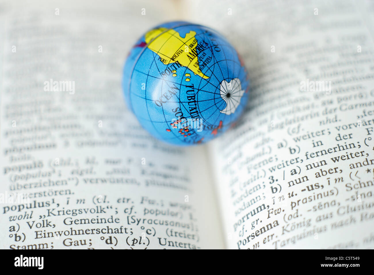 Germany Close Up Of Earth Globe On Open Dictionary Stock - 