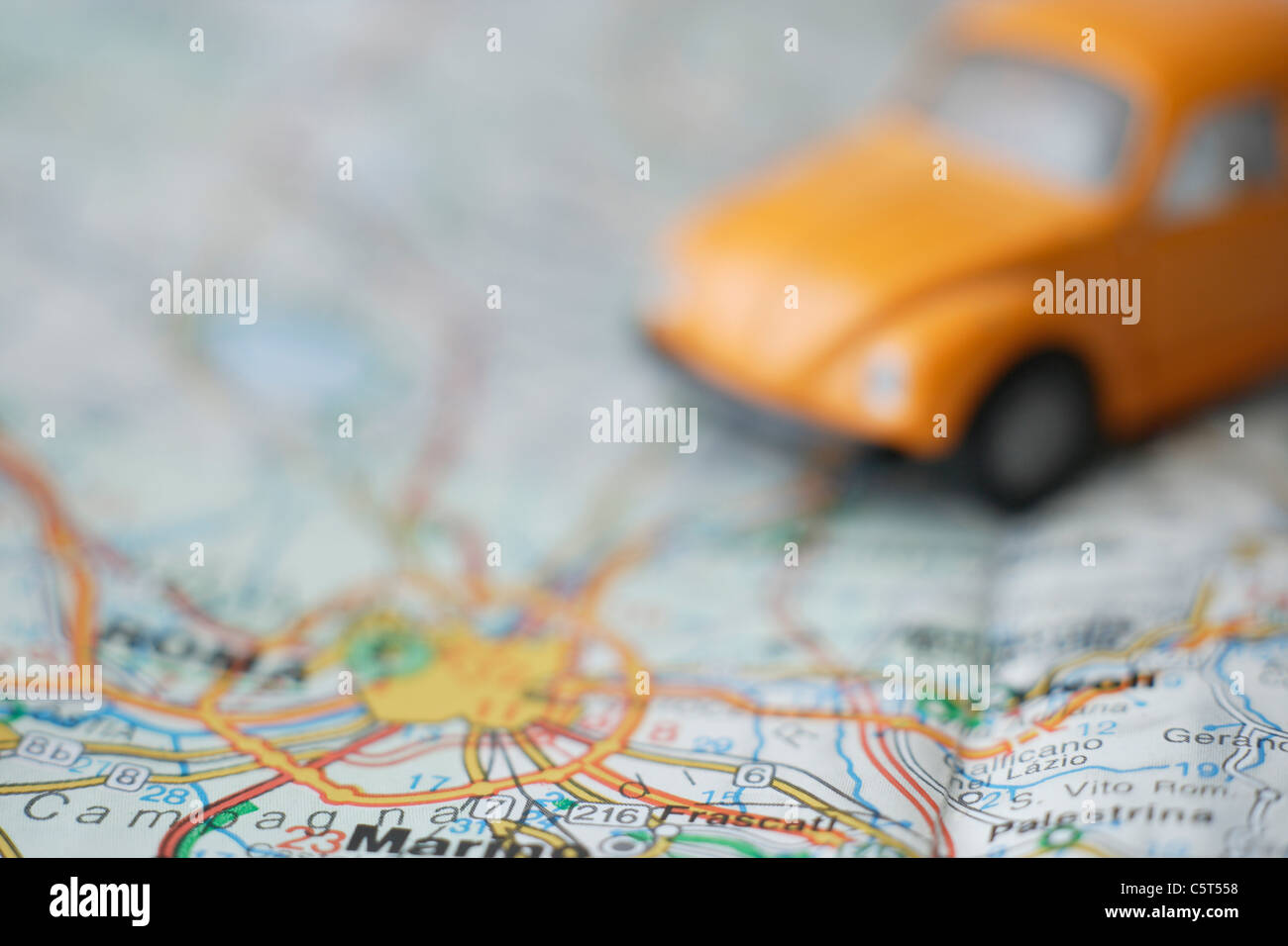Italy, Rome, Close up of beetle toy car on road map Stock Photo