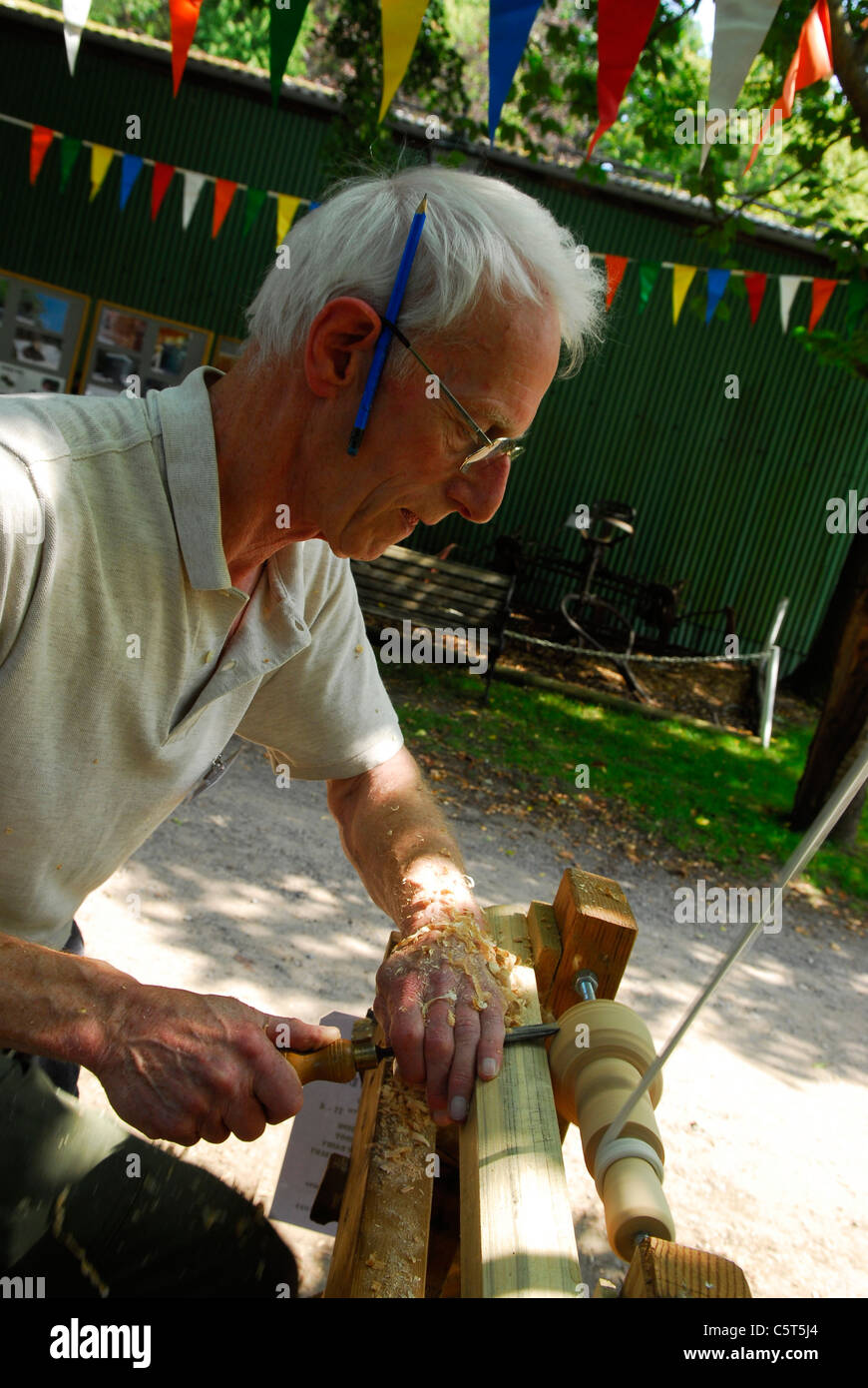 Man demonstrating how to make a spinning top at rustic sunday an