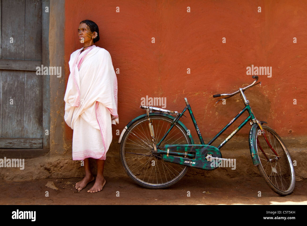 A tribal woman from Orissa India in front of her house Stock Photo