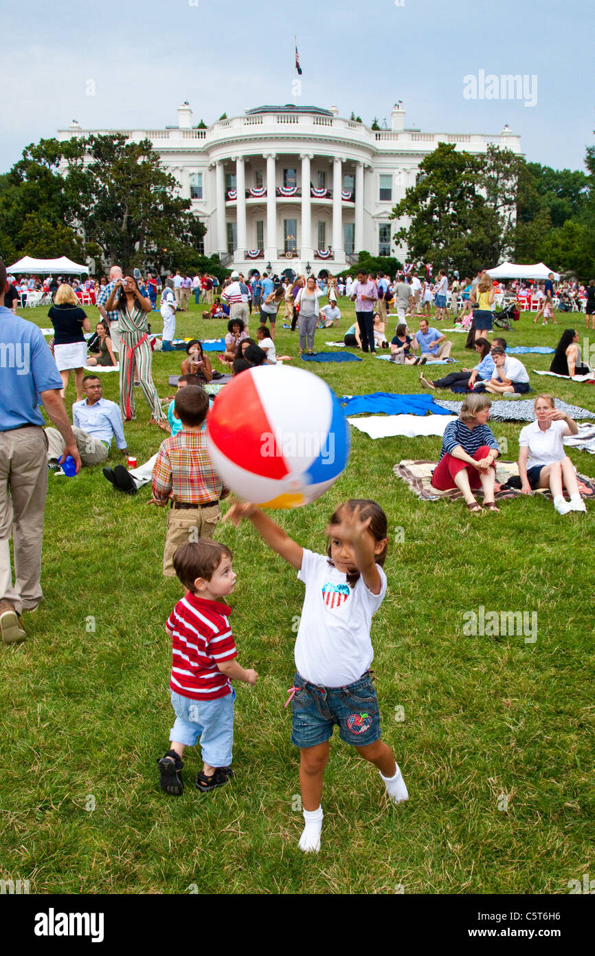 Girl throwing a ball on the White House lawn on the 4th of July, Washington DC Stock Photo