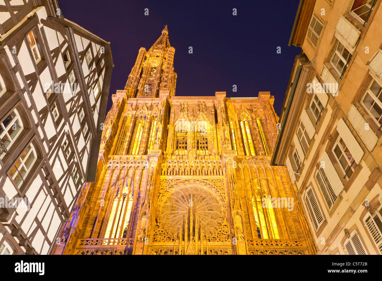 France, Alsace, Strasbourg, View of Notre Dame cathedral and frame houses at night Stock Photo
