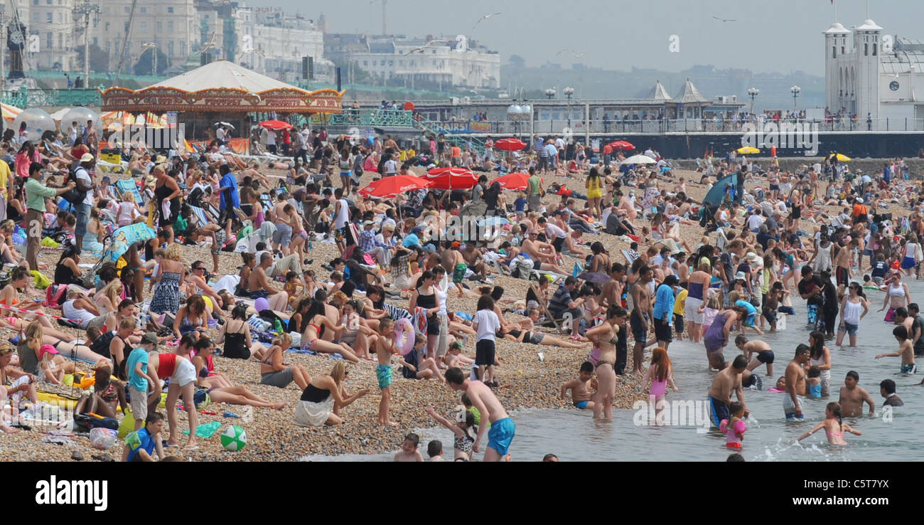 A packed Brighton beach today with the seafront behind as crowds enjoyed the soaring