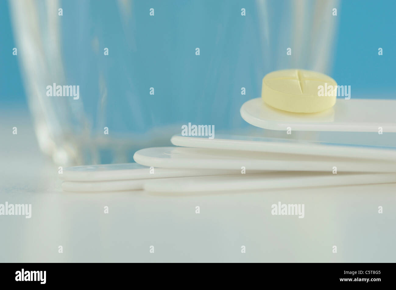 Tongue depressors, pill and a glass Stock Photo Alamy