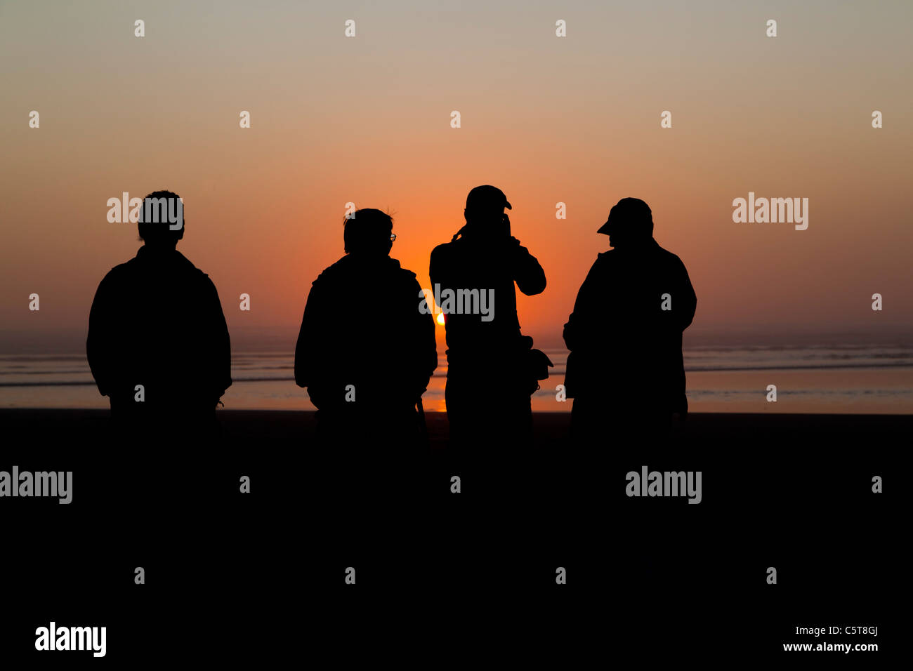 Sunset silhouettes at Cannon Beach Oregon USA Stock Photo - Alamy