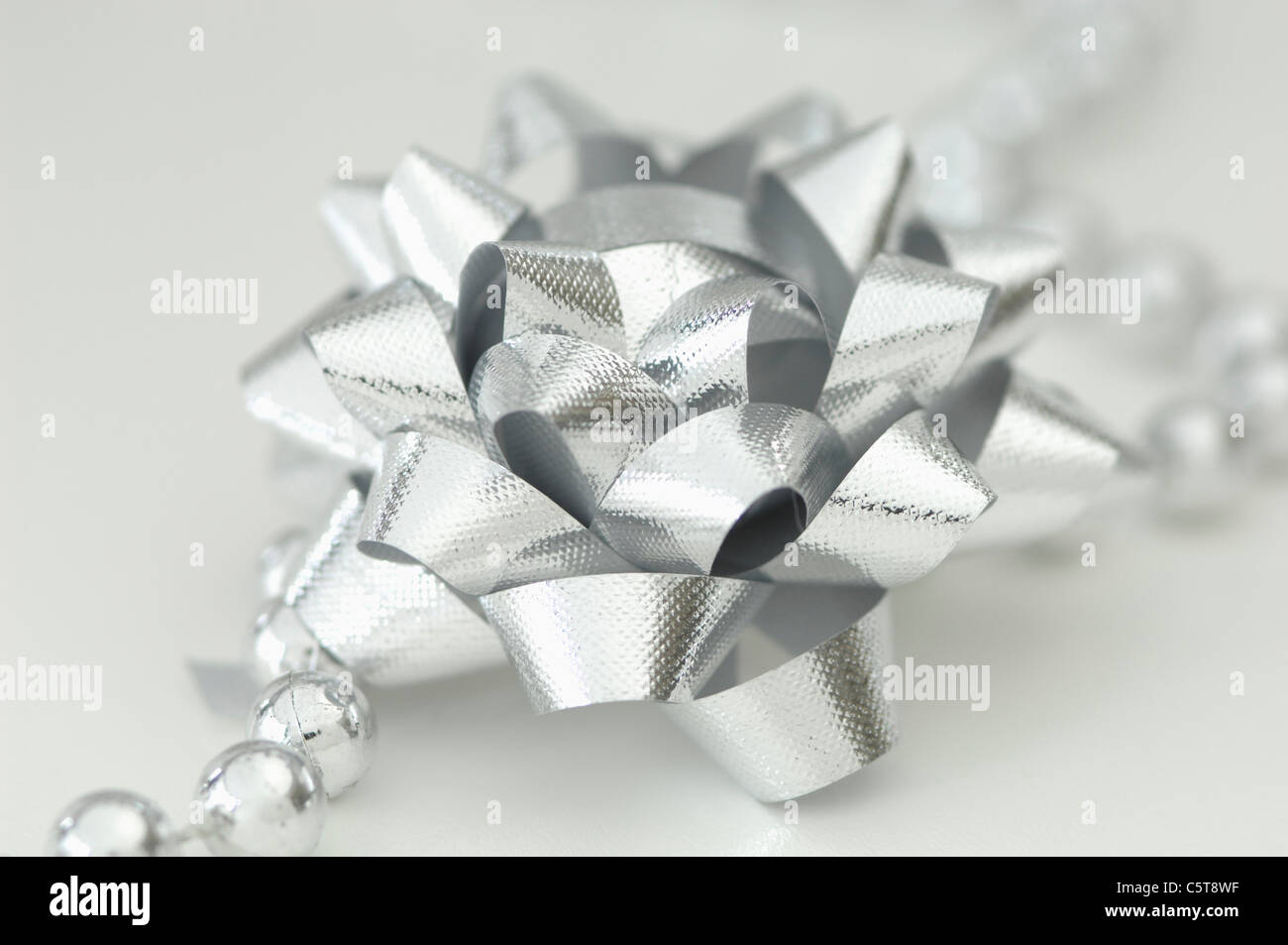 Silver ribbon, bow and pearls Stock Photo Alamy