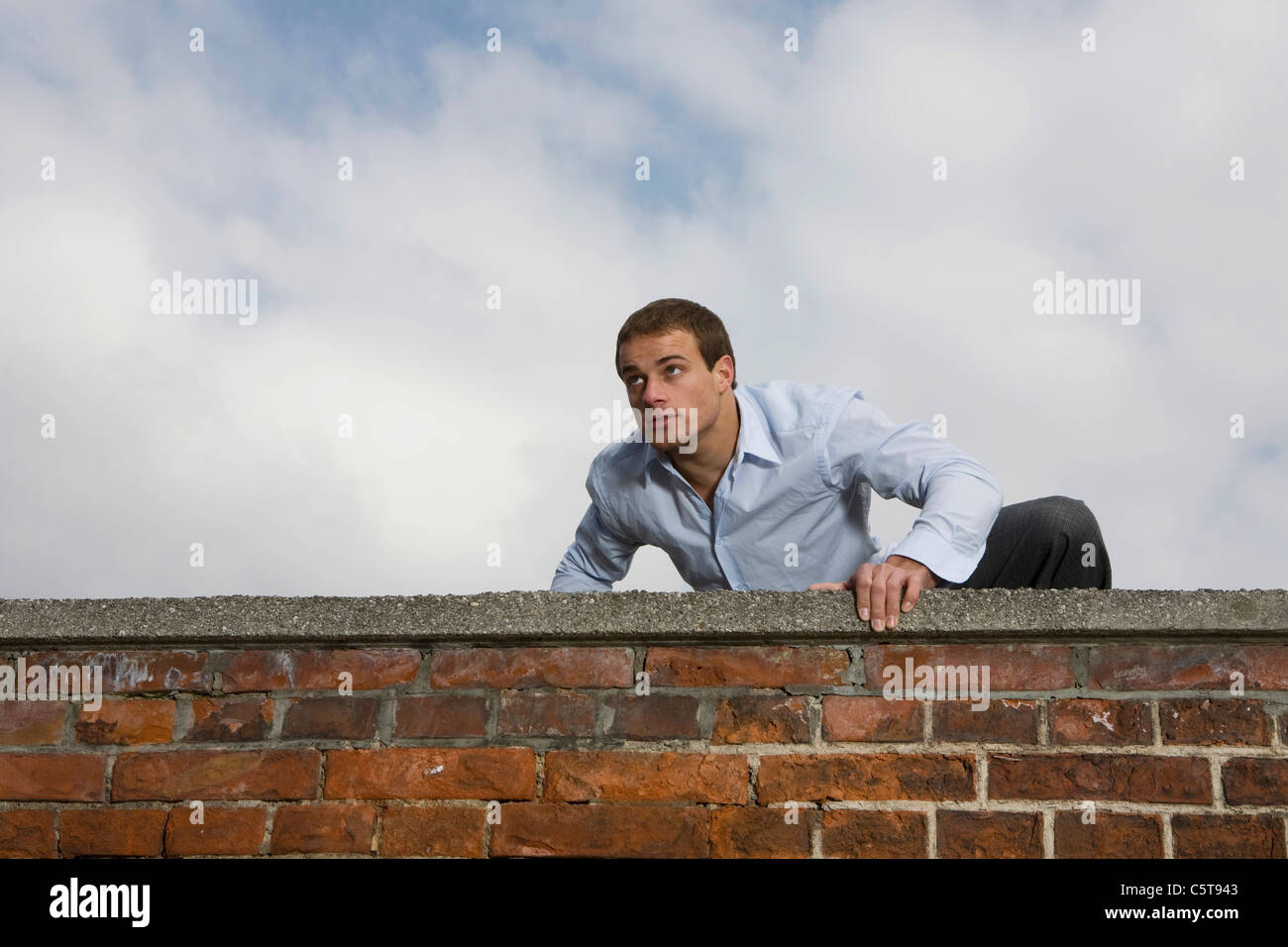 Man climbing over wall hires stock photography and images Alamy