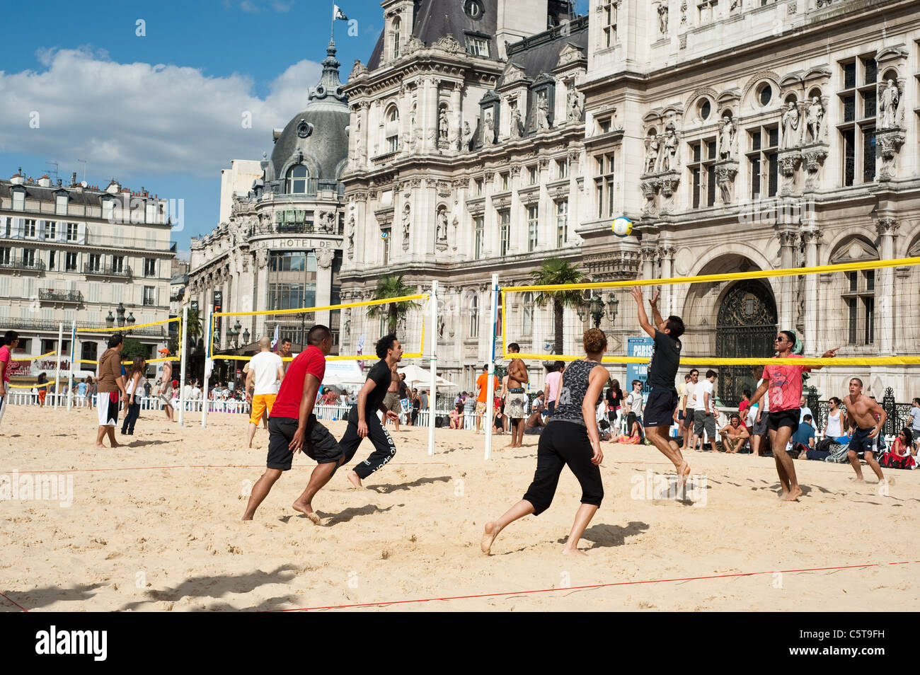 People playing beach volleyball on an artificial field in  front of City Hall during the Paris Plage event, Paris, France. Stock Photo