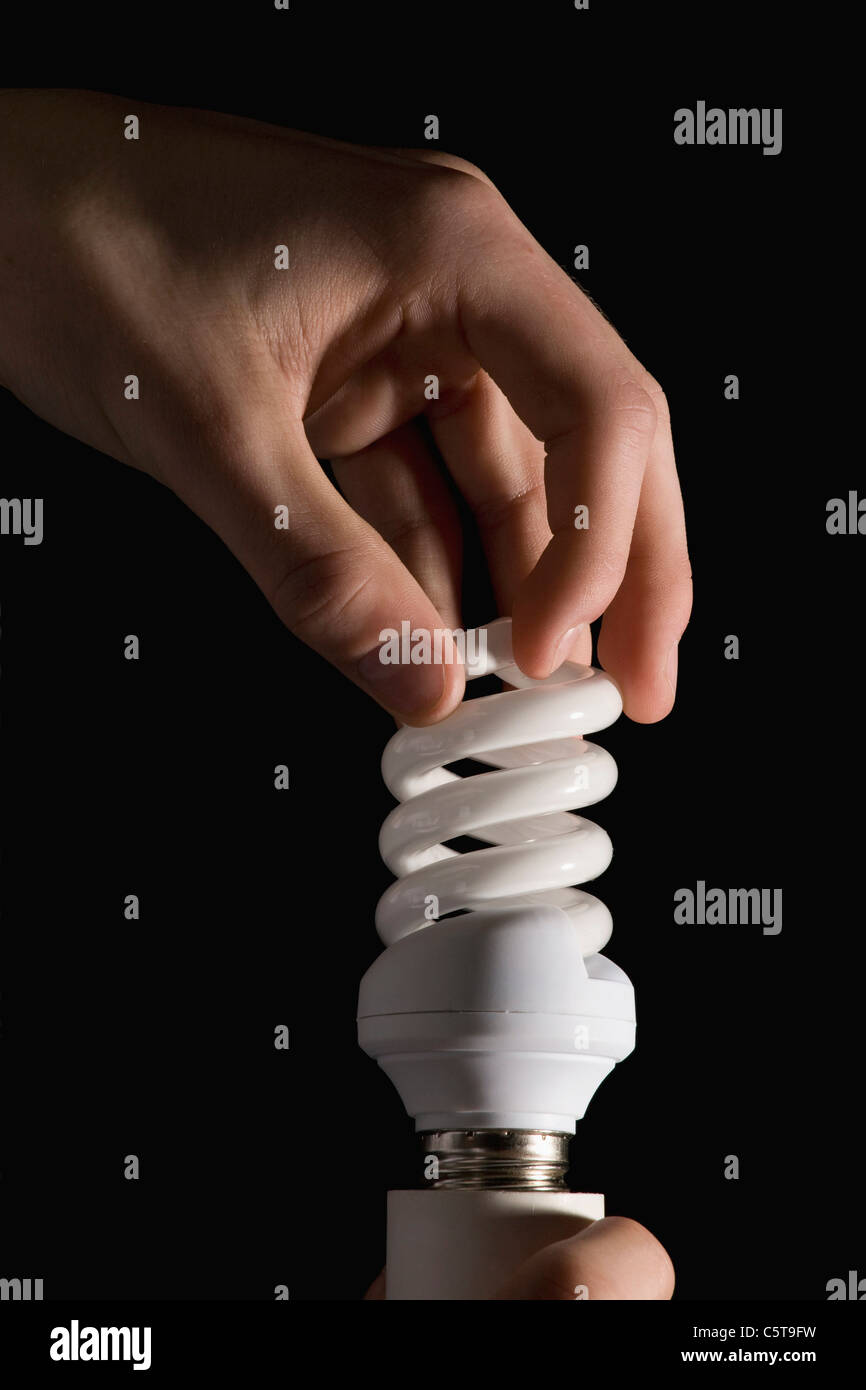 Hand holding energy-saving lamp Stock Photo