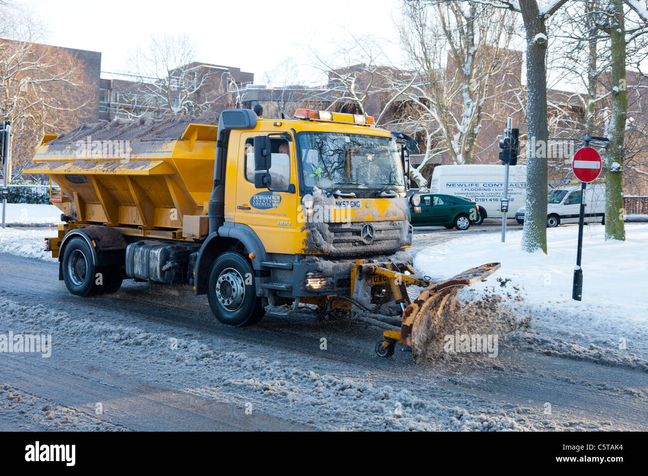 Snow plough clearing the road in Durham England UK Stock Photo