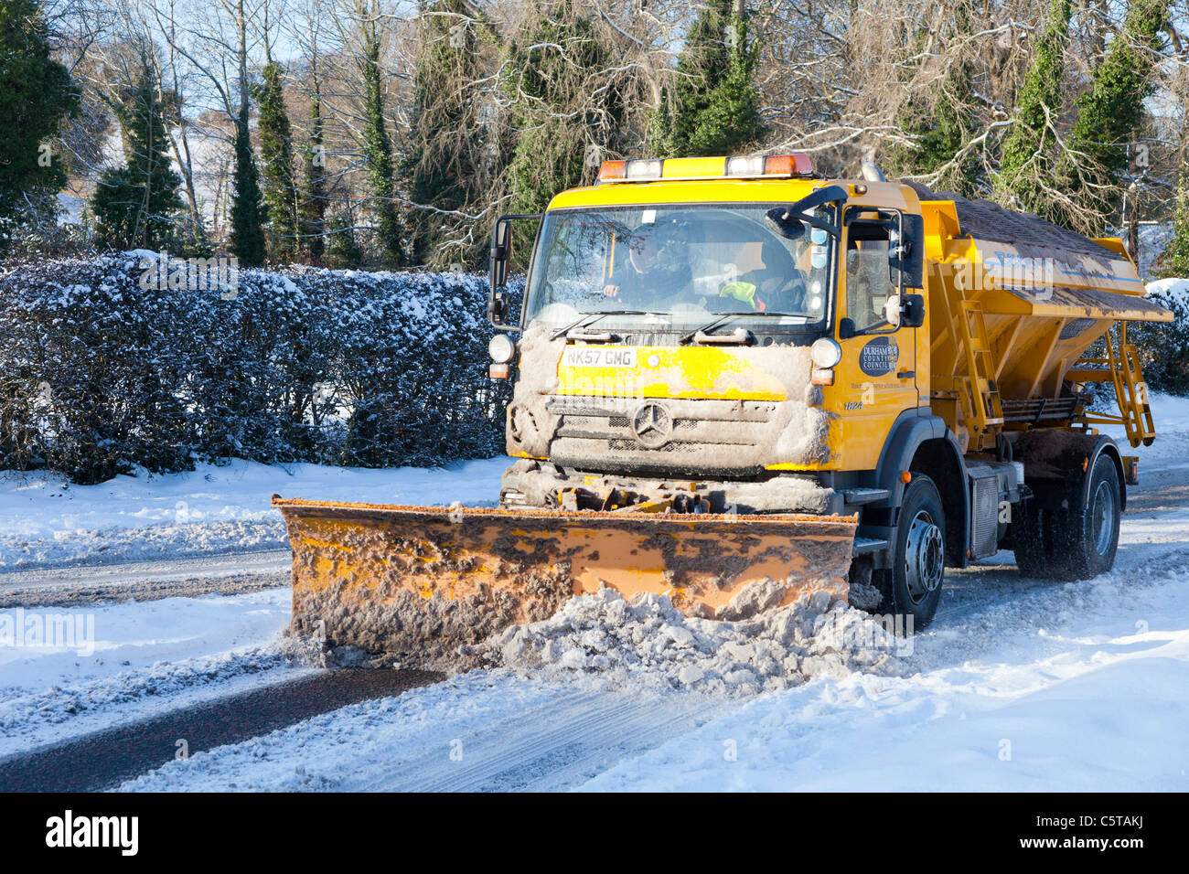 Snow plough clearing the road in Durham England UK Stock Photo