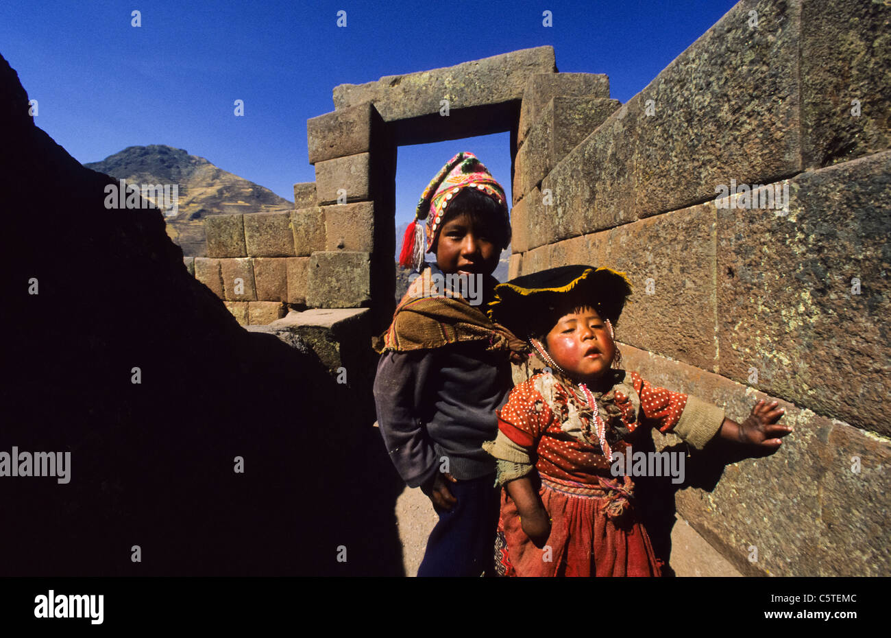 Small boy and girl in indian dress at the Pisac Inka ruins, Peru Stock Photo