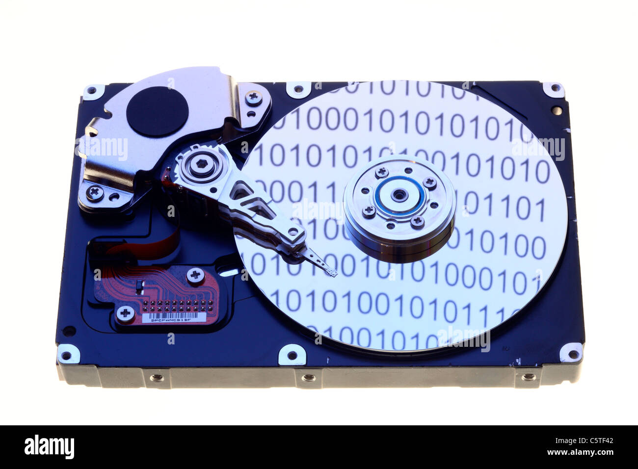 Computer hard drive, opened, writing/reading head and hard disk. Binary code numbers are reflecting on the hard disc. Symbol. Stock Photo