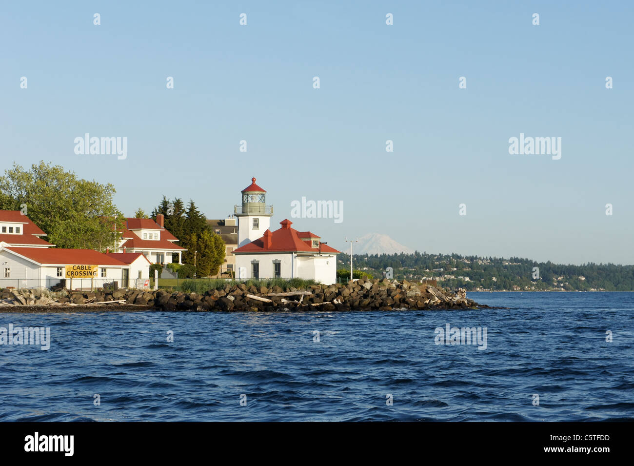 Alki Point Lighthouse in Seattle with Mount Ranier in the background to the right. Stock Photo