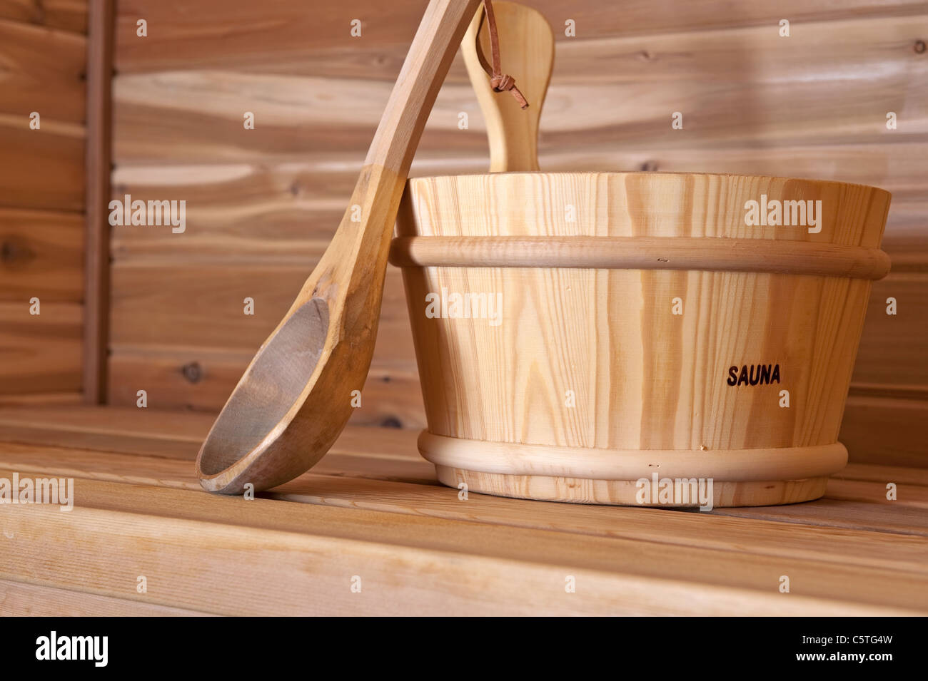 wooden bucket and ladle within a hot sauna Stock Photo