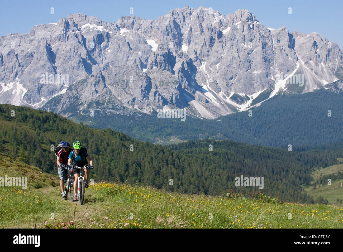 Italy, Dolomites, Couple mountainbiking Stock Photo