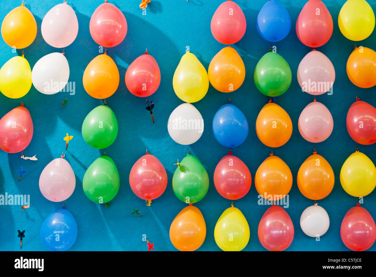 Germany, Bavaria, Munich, Multi coloured balloons and dart at oktoberfest Stock Photo