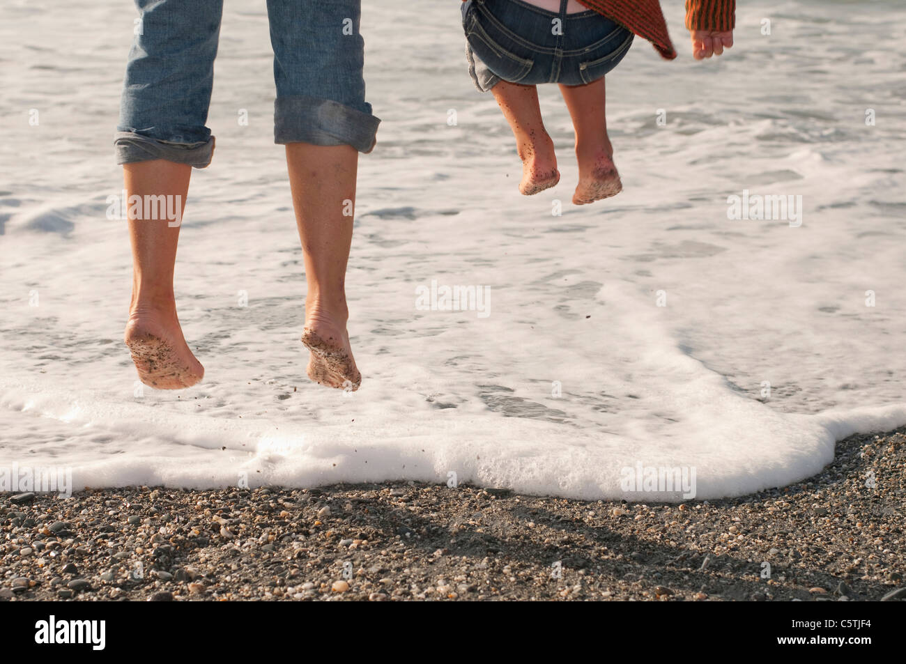 New Zealand, Okarito, Persons on shore, fooling about, low section Stock Photo