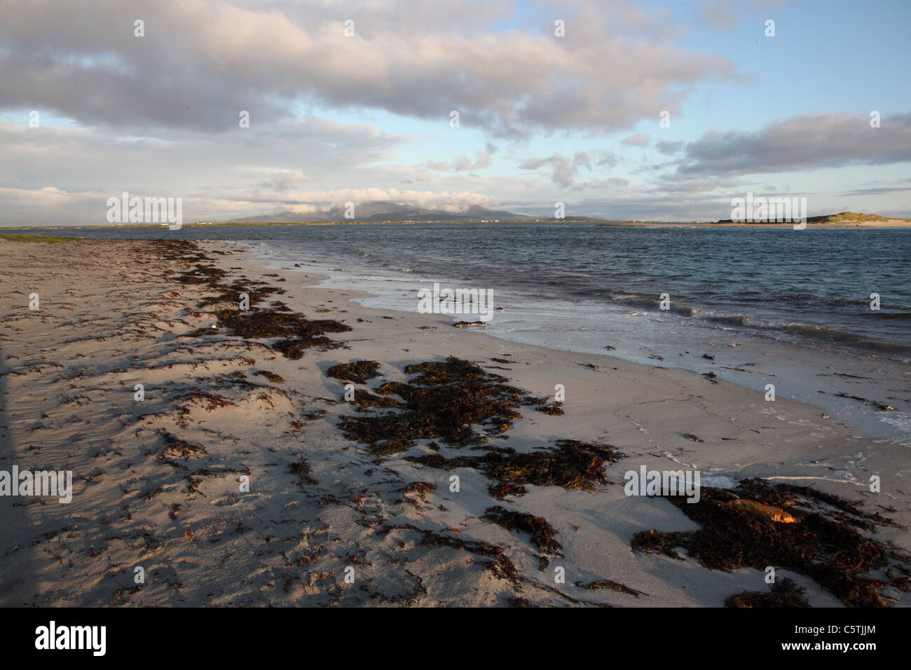 The beach at Eilean Siar, Benbecula, Outer Hebrides looking towards the mountains of South Uist Stock Photo