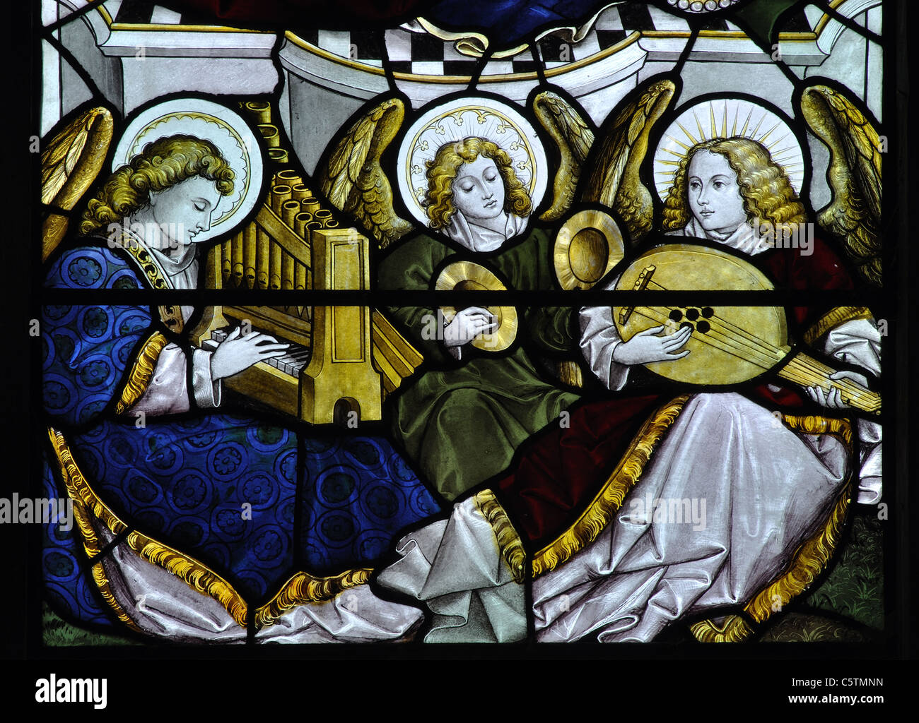 Angel musicians stained glass, All Saints Church, Crudwell, Wiltshire, England, UK Stock Photo