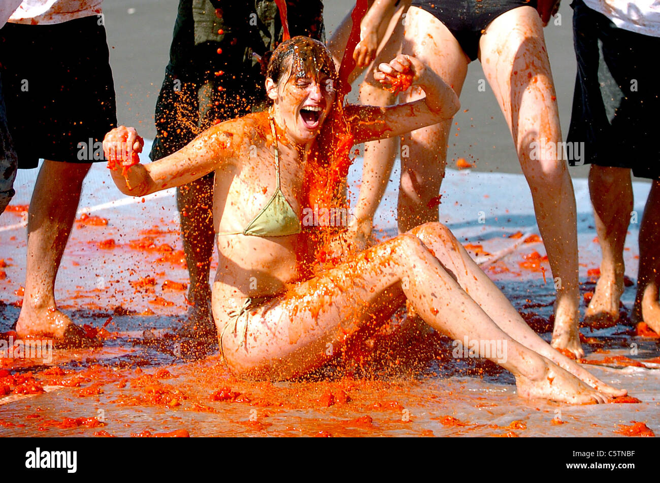 Valeria Fossatti gets covered in tomatoes as staff from Pintxo People restaurant in Brighton took part in a tomato fight Stock Photo