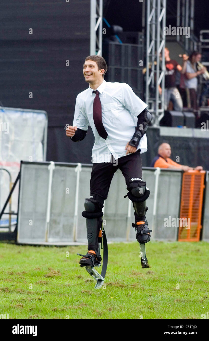 Young man wearing stilt walkers which enable the wearer to jump very