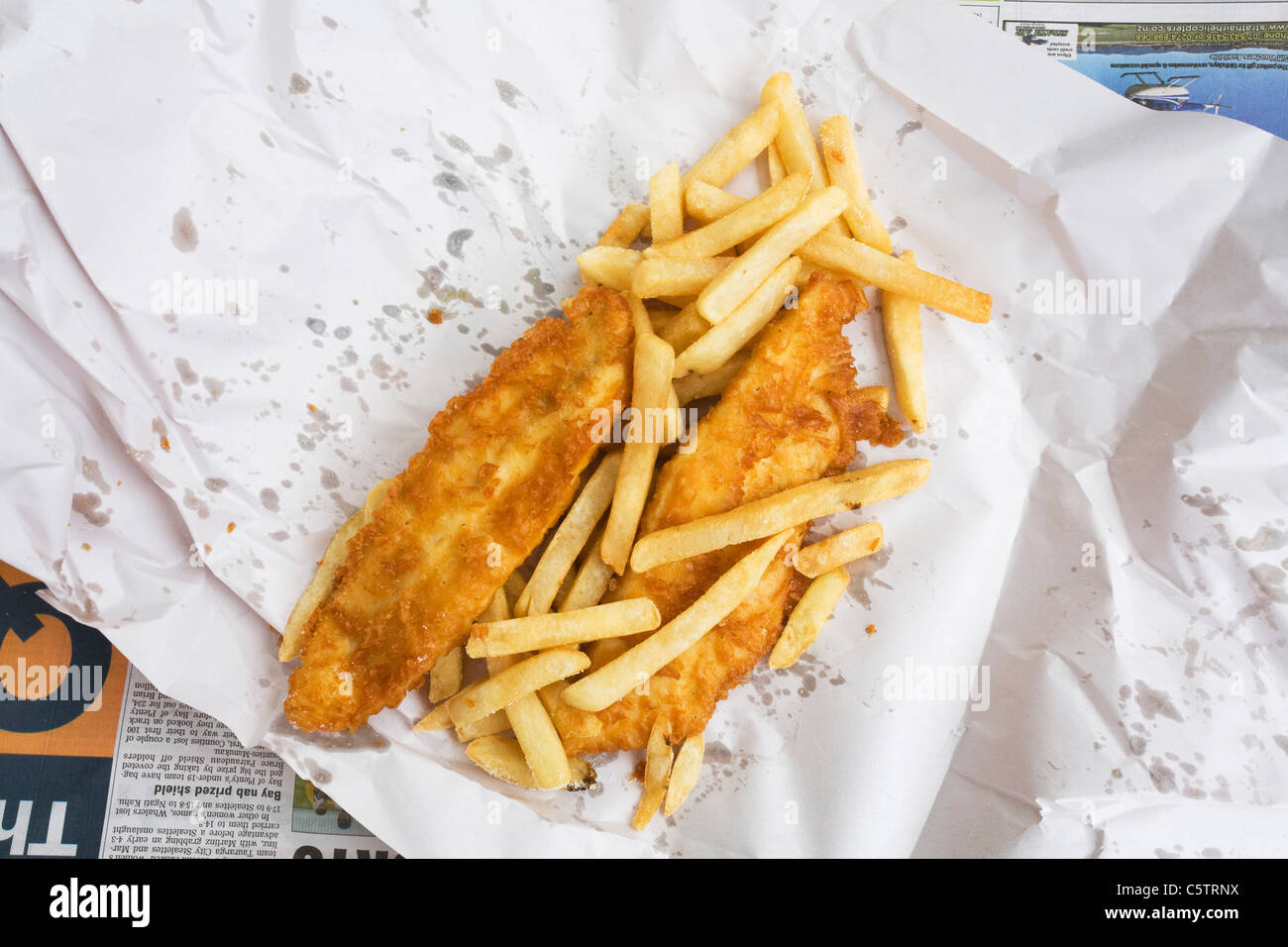 British fish and chips on paper, elevated view Stock Photo