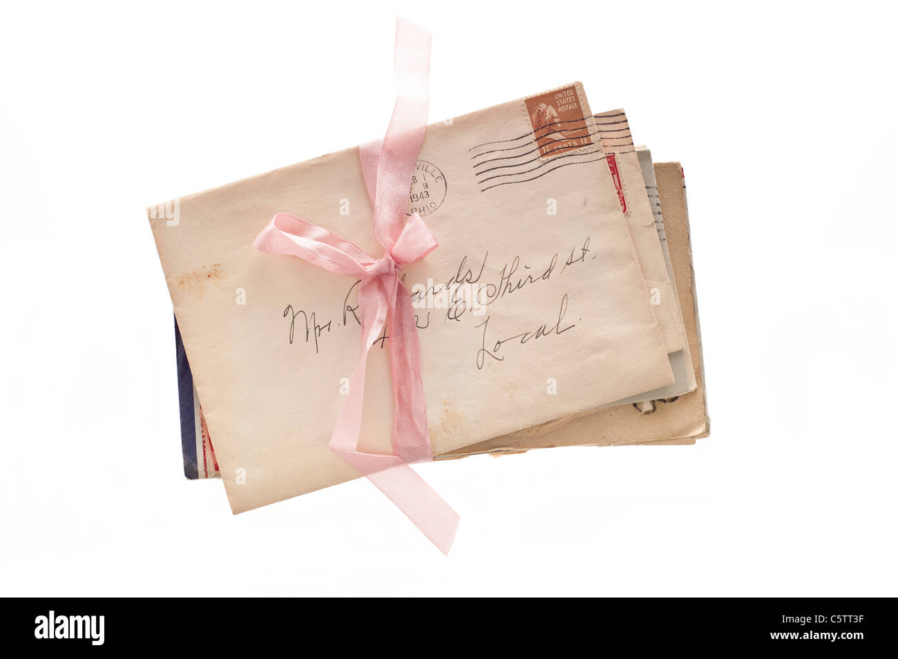 package of old envelopes with a pink ribbon Stock Photo